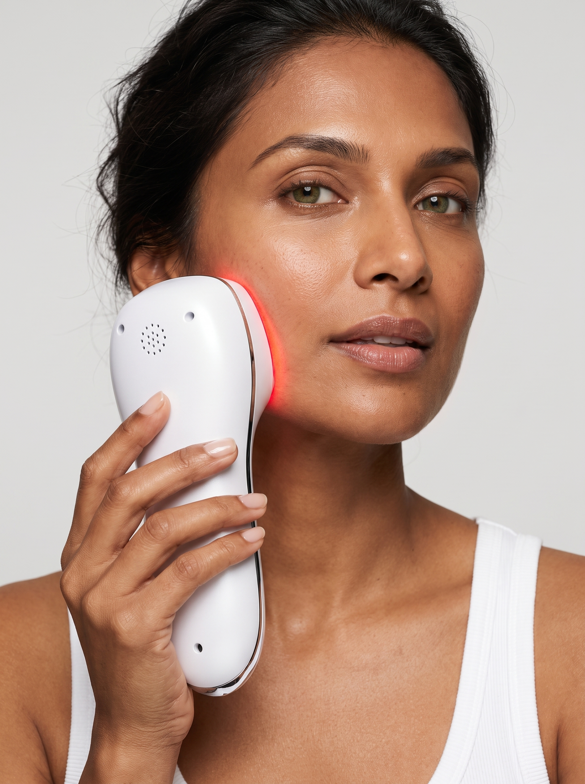 Woman holding the Home Electronic Beauty Device to her cheek