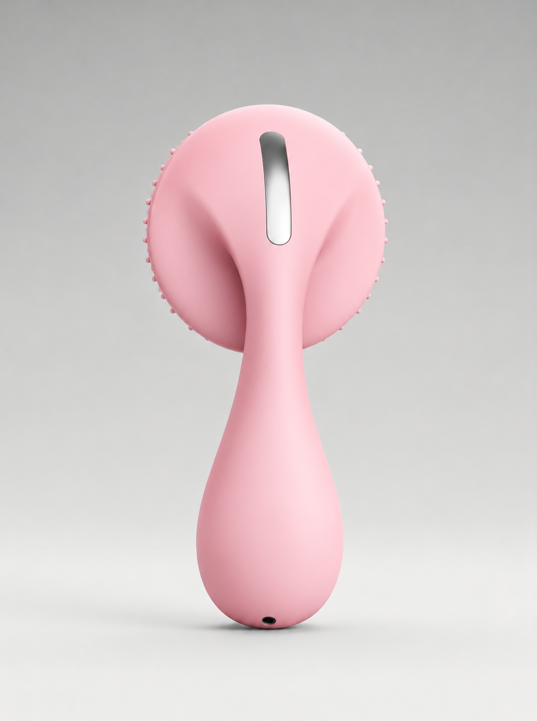 Silicone Facial Cleansing Device in pink, back view